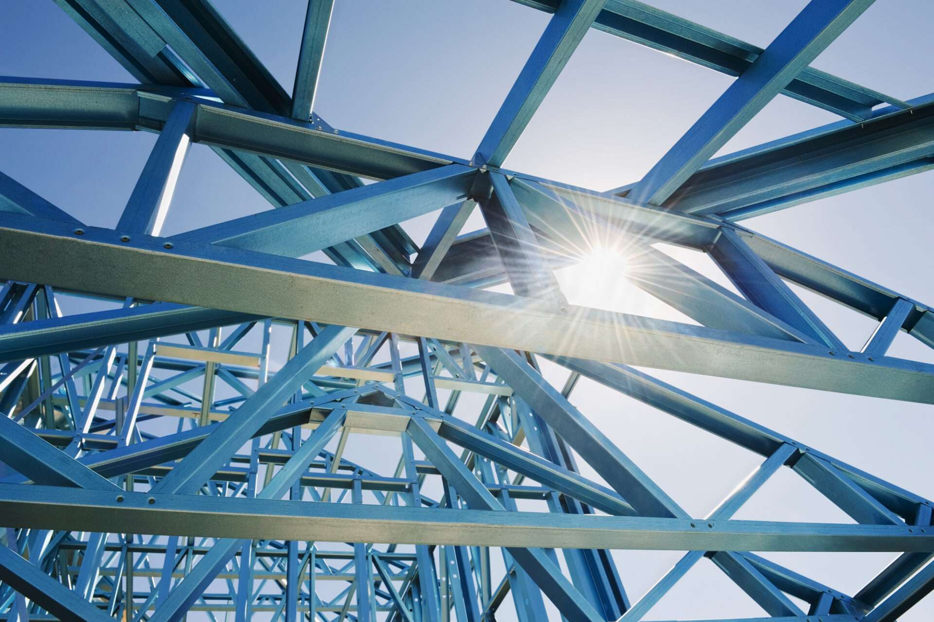 New home construction framing. New home under construction using steel frames against a sunny sky.